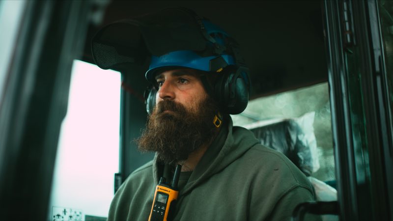 Andrew in the cab wearing ear defenders