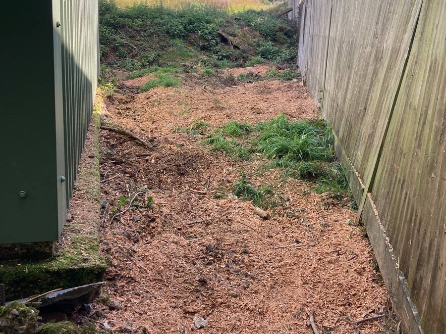The same passage cleared end to end, chippings across the ground